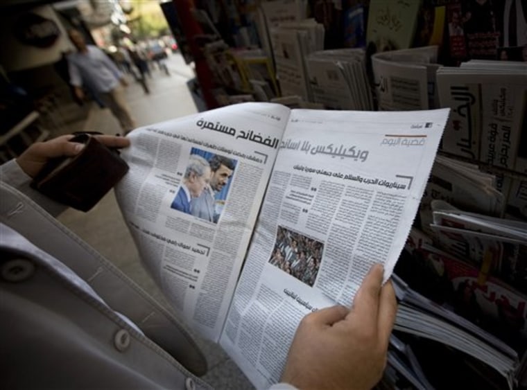 A man shows an inside page of Lebanon's daily Al-Akhbar carrying a report leaked by the website WikiLeaks, in Beirut's commercial Hamra street, Lebanon, on Thursday. Omar Nashabe, an editor of the Lebanese daily Al-Akhbar says the newspaper's website suffered severe technical problems after being attacked apparently over its publishing of leaked U.S. diplomatic cables.
